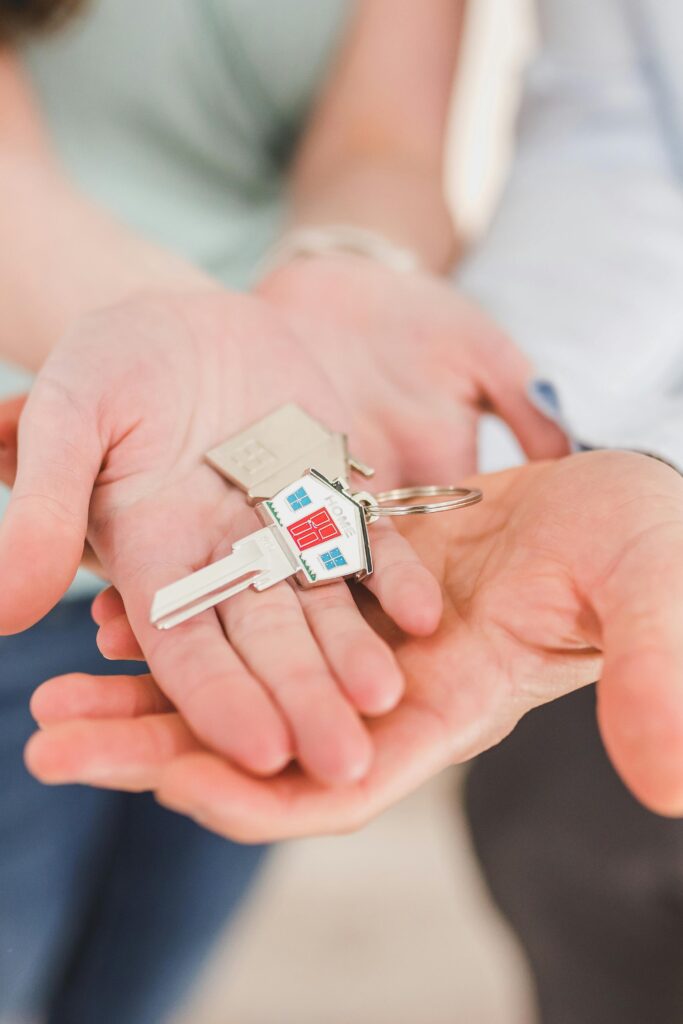 Two hands holding a house key